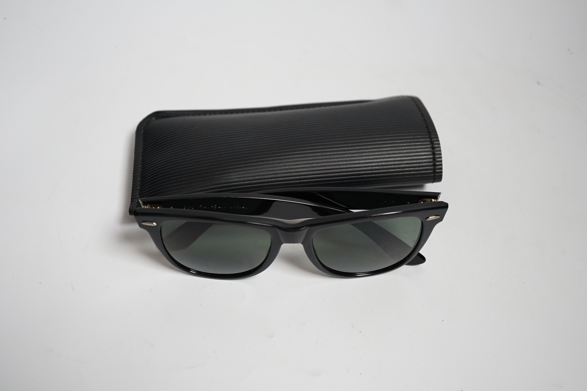 A pair of vintage Ray Ban Wayfarer sunglasses, with case and box, virtually unused.
